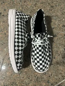 Black and white checkerboard casual slip-on flat shoes with elastic laces for women.