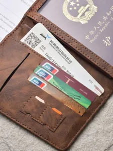 Multifunctional brown leather passport holder travel wallet with card slots and boarding pass pocket.