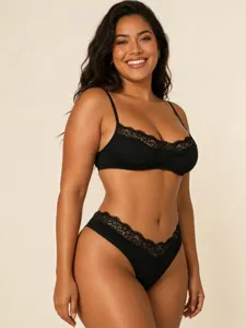 Detailed view of French sexy black lace underwear set, wireless bra and thong style.