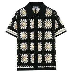 Detailed view of the black and white crochet knit polo shirt showing intricate square pattern.