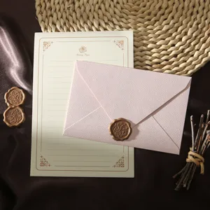 Vintage retro stationery set with pink textured envelope, letter paper and wax seal.