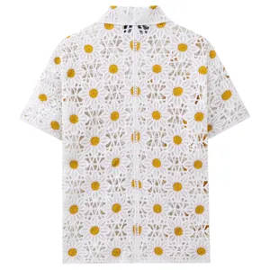 Men's white crochet knit short sleeve polo shirt with yellow daisy floral pattern detail.