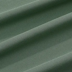Detailed close-up view of green breathable mesh fabric texture for summer polo shirt.