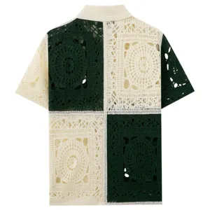 Detailed view of the men's color-block crochet knit polo shirt with intricate hollow floral motifs.
