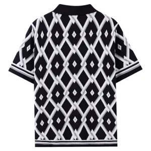 Close-up of the black and white geometric knit pattern, textured fabric and ribbed polo collar.