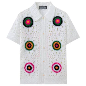 White crochet knit short sleeve shirt featuring colorful floral patterns and polo collar.