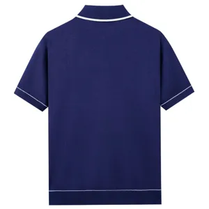 Back view of dark blue knit polo shirt with contrast white trim detail on collar and sleeves.