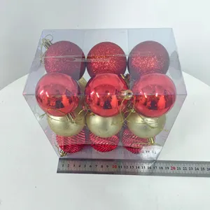 Detailed view of boxed Christmas baubles set, assorted red and gold plastic hanging ornaments.