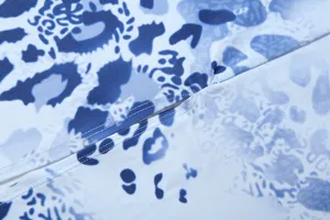 Close-up detail of women dress fabric featuring blue printed pattern and neat stitching.