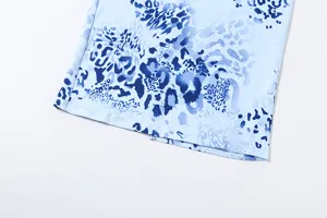 Detail view of the blue abstract leopard print women's dress fabric and hemline.