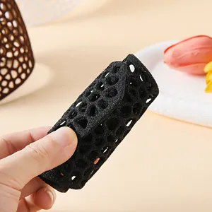 Close-up detail of black mesh sponge hair curler showcasing breathable honeycomb texture.