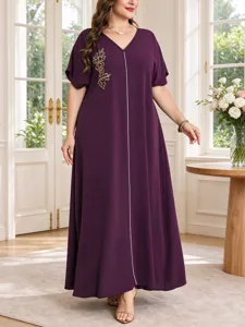 Detail view of elegant purple plus size long dress featuring V-neck and delicate gold leaf embroidery.