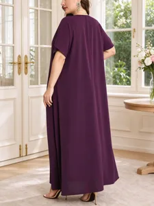 Plus size solid purple maxi dress detail, flowing short sleeve draped fabric look in room.