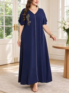 Close-up detail of the elegant V-neck plus-size maxi dress with delicate gold leaf embroidery.