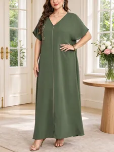 Detailed view of the elegant dark green plus size maxi dress with leaf embroidery and V-neck.