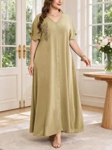 Detail shot of women's V-neck leaf embroidered plus size maxi dress, elegant summer long robe style.