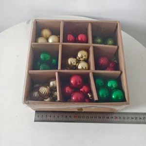 Close-up of assorted color Christmas ball set in a 9-grid box, perfect for holiday tree decor.