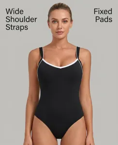 Close-up detail of women's black activewear tennis dress with white contrast trim straps.