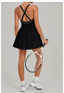 Back view detail of black athletic tennis dress with cross straps and pleated skirt for sports.