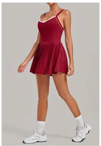 Detailed view of the maroon athletic tennis dress featuring a pleated skirt and white contrast trim.