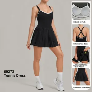 Black athletic tennis dress with built-in bra pads, cross back, and pleated skirt design.