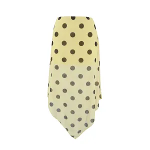 Detail view of yellow polka dot sheer mesh fabric, asymmetric layered hem design for women apparel.