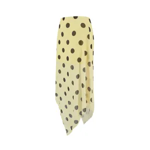 Detailed view of the yellow polka dot mesh skirt showing asymmetric hem and double layers.