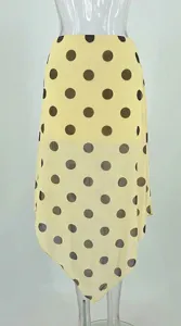 Detailed shot of yellow polka dot mesh double layer asymmetrical midi skirt, sheer draped fabric.