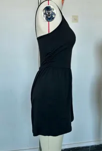Side view detail of a black sleeveless strapless romper jumpsuit, showing slim fit and side design.
