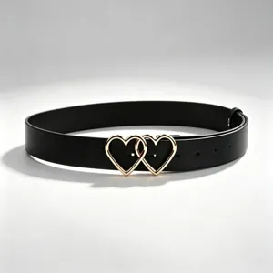 Detailed view of women black PU leather belt featuring a chic gold double heart buckle design.