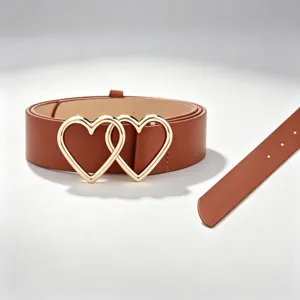 Detail view of the brown PU leather belt featuring interlocking gold-tone heart buckles for women.