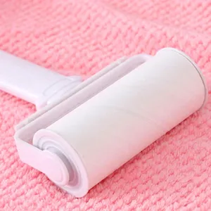 Lint roller detail shot showing sticky paper roll and handle for easy pet hair removal.