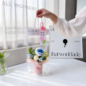 Handmade crochet blue rose flower bouquet in a clear gift bag detail scene display.