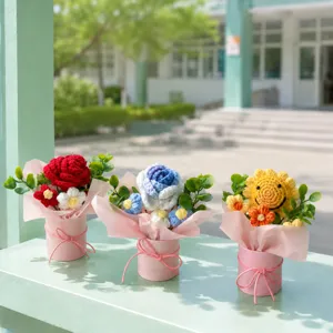 Handmade crochet flower bouquet detail view, featuring colorful yarn blooms in pink pot.