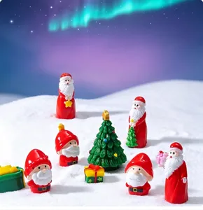 Christmas miniature Santa Claus resin figures and tiny tree set for holiday decor detail shot.