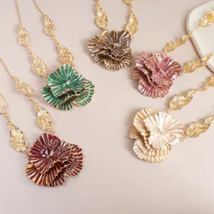 Close-up detail shot of multi-color metal flower pendant necklaces with leaf chain designs.
