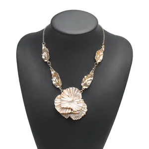 Detailed shot of the exaggerated layered flower pendant necklace with metallic leaf accents.