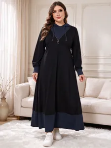 Detailed view of a plus-size color-block hooded maxi dress with long sleeves and zipper.