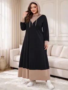 Detail view of the plus-size long sleeve color block hooded dress showing the texture and hem.