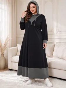 Detail view of the plus-size colorblock hooded maxi dress featuring contrast long sleeves.