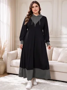 Plus-size long sleeve hoodie dress detail view, featuring contrast color panels and zip collar.