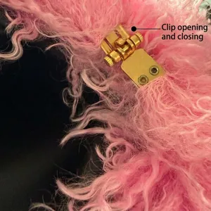 Pink fluffy faux fur cloud shoulder bag detail view with luxury gold metal clasp closure.