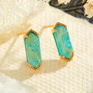 Close-up detail of geometric hexagonal turquoise rutilated quartz stud earrings with golden finish.