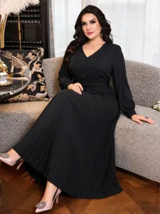 Detailed view of the elegant black long sleeve maxi dress featuring delicate lace V-neck and pleated skirt.