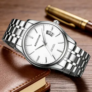 Close-up detail of a classic men's metal strap watch with white dial and clear calendar window.