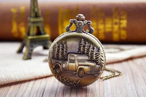 Vintage bronze pocket watch with carved pickup truck and pine trees design, steampunk style.