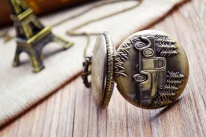 Vintage bronze pocket watch with car relief design and long chain for men and women retro gift style