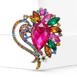 Detail view of a fashionable heart-shaped crystal rhinestone brooch with colorful glass gems.