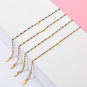 Detailed display of dainty stainless steel beaded cross bracelets showcasing assorted colors.