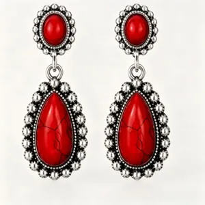 Detailed close-up of vintage red turquoise earrings with antique silver beaded fringe design.